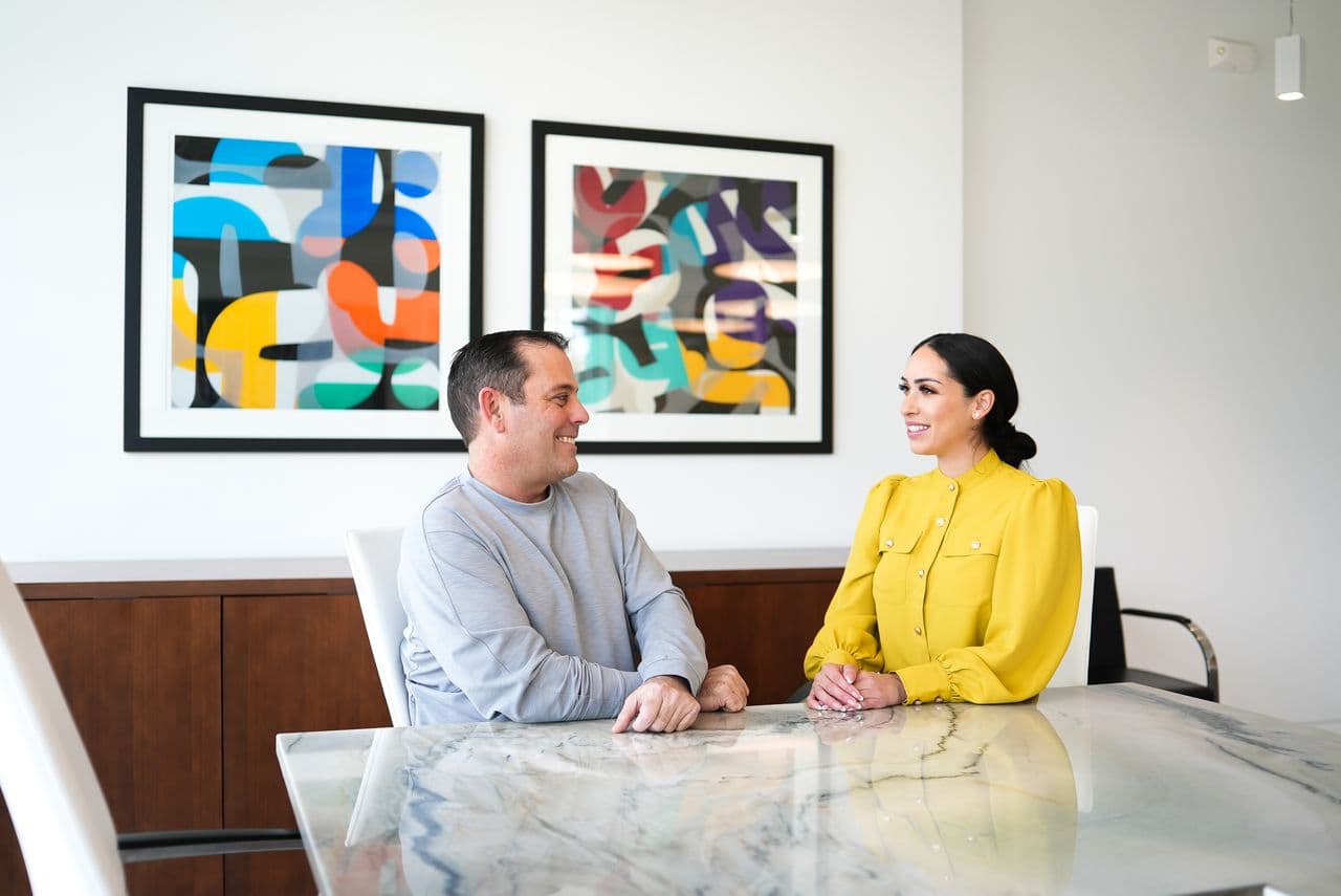 Two professionals meeting in a modern office.