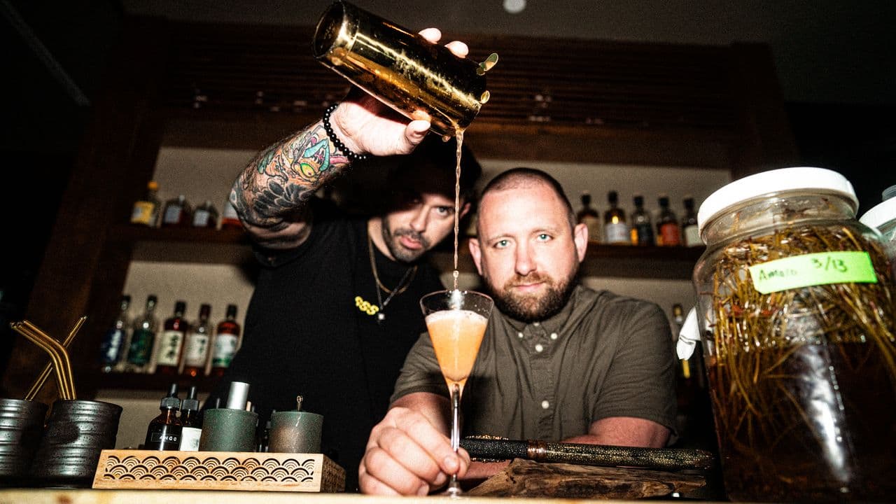 A polished cocktail pour, ad-style imagery.