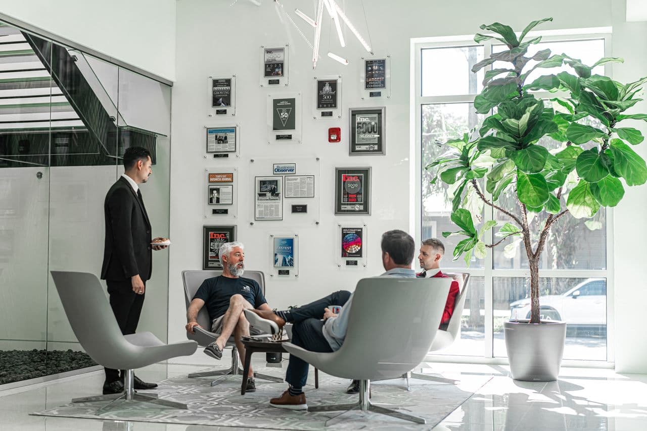 A corporate office lobby with press and award coverage on the wall.