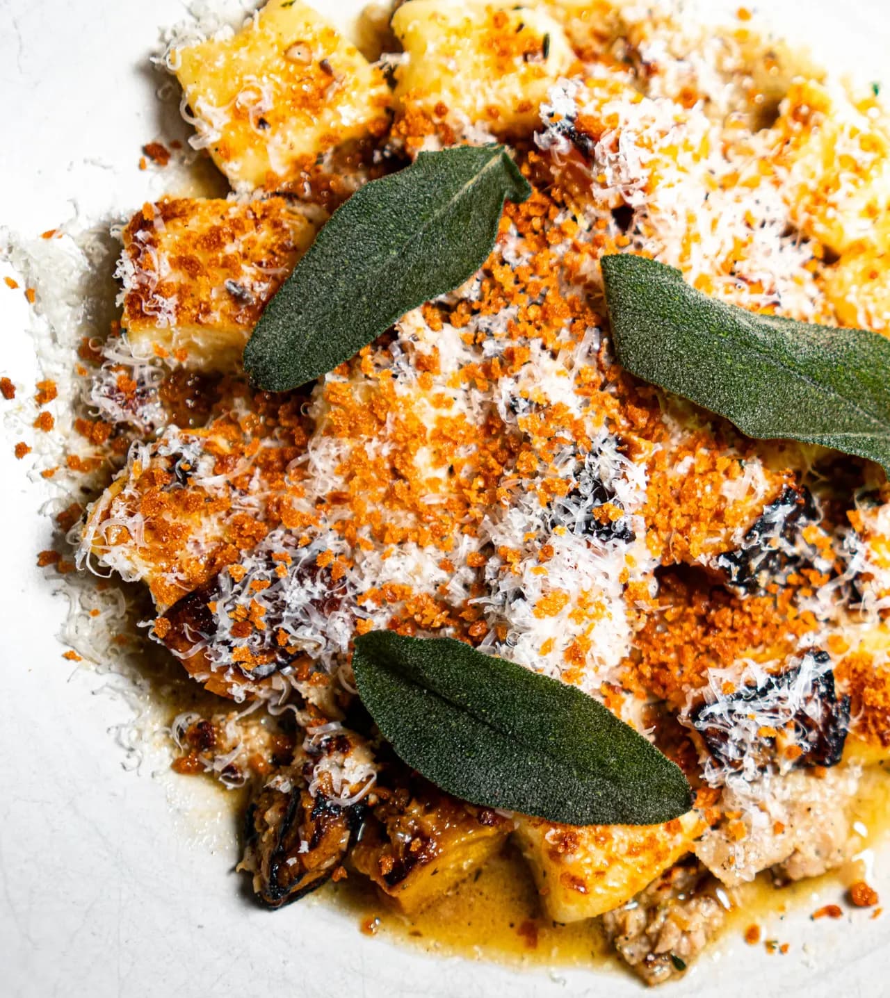 Close-up of golden gnocchi, sage and parmesan at Olivia