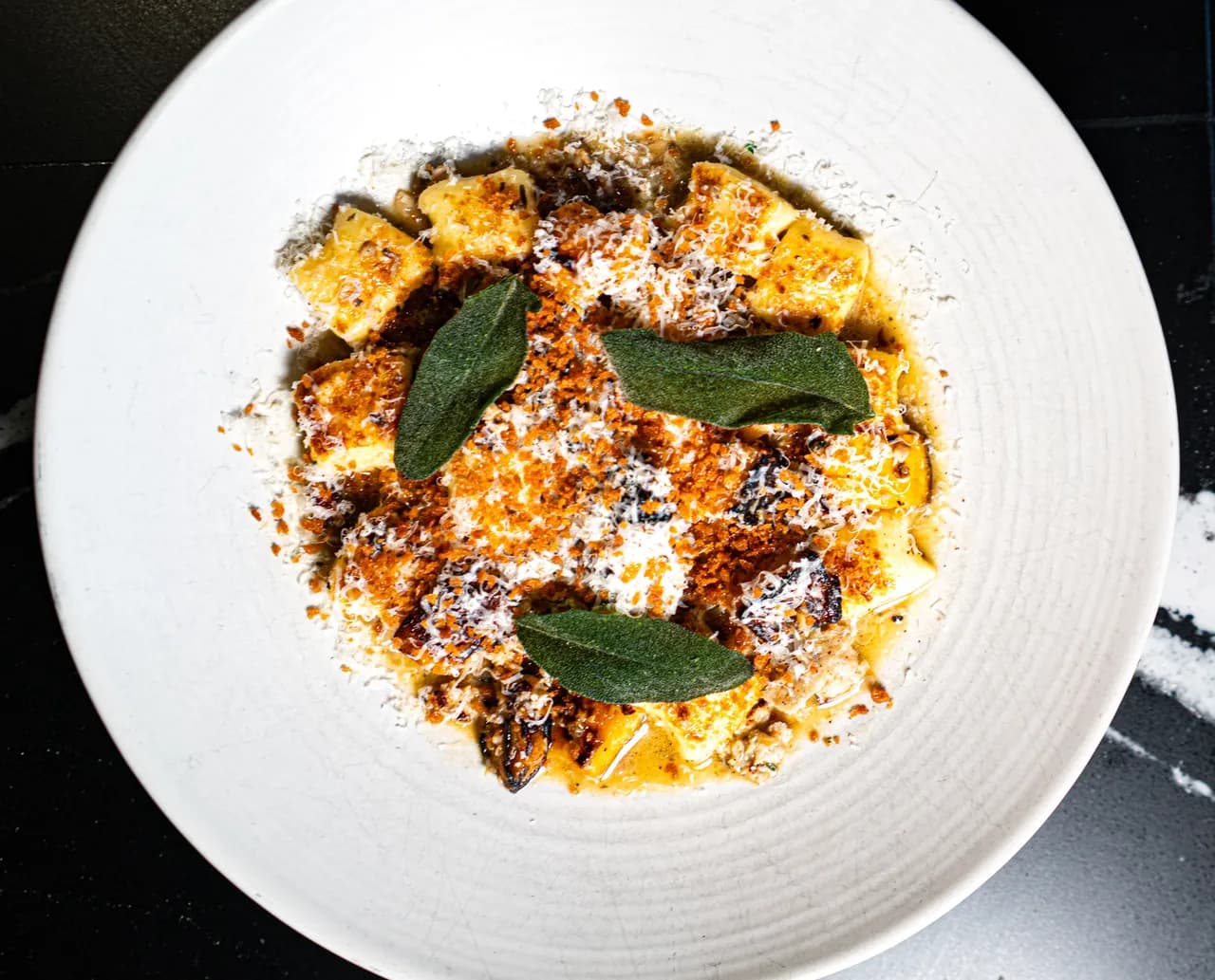 Overhead: a bowl of Olivia’s gnocchi with sage and parmesan
