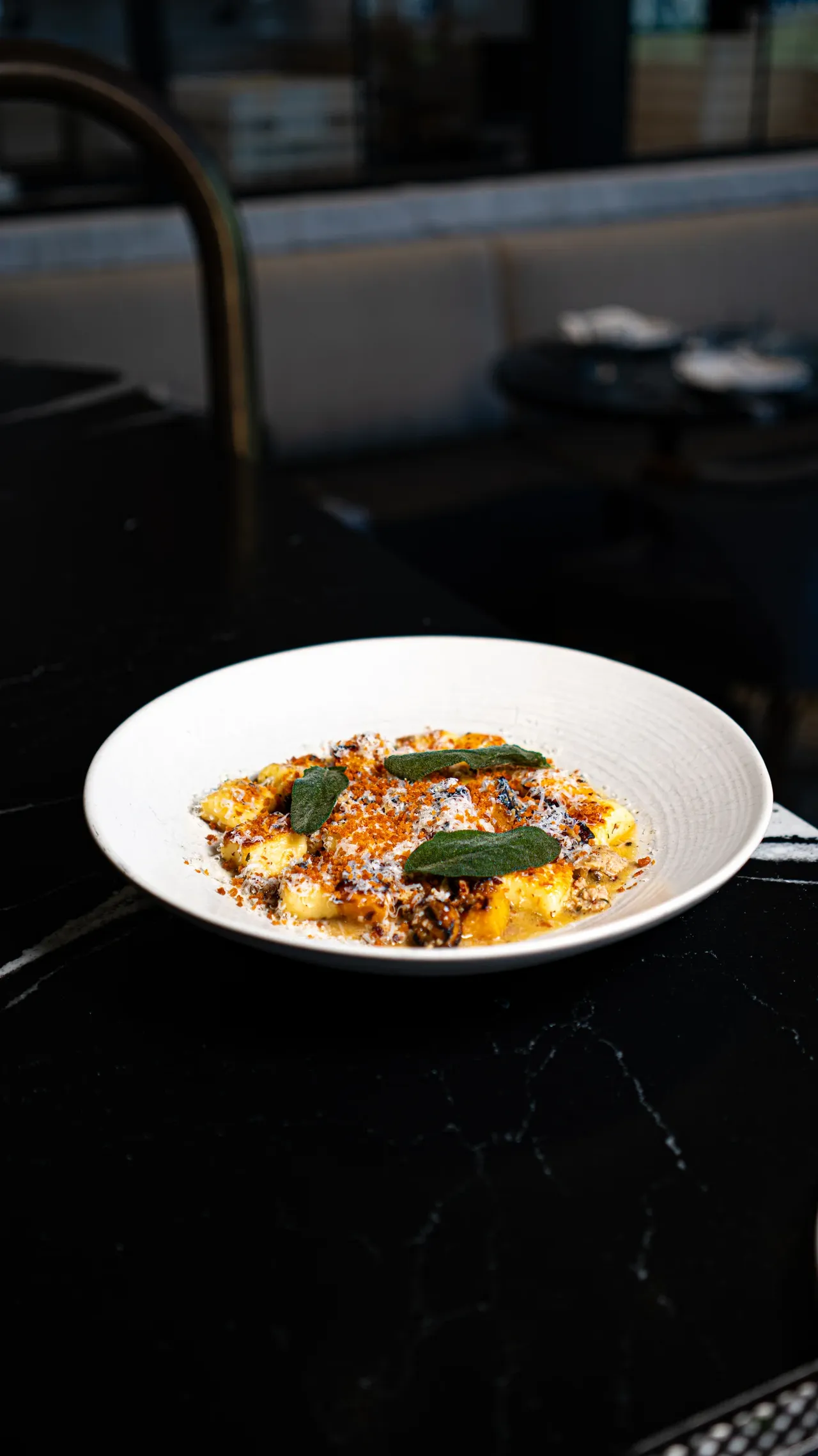 Pan-seared gnocchi with fried sage and parmesan, on the bar at Olivia