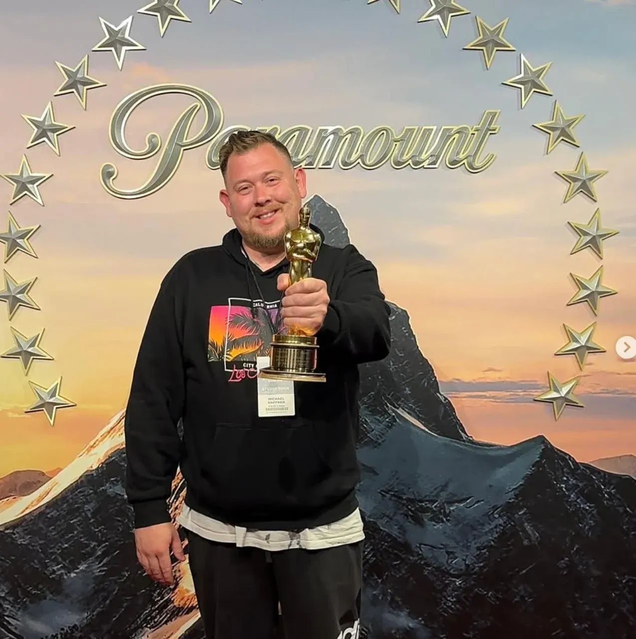 Michael Haffner holding an award statuette in front of a Paramount-style backdrop